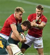 31 July 2021; Kwagga Smith of South Africa is tackled by Duhan van der Merwem, left, and Chris Harris during the second test of the British and Irish Lions tour match between South Africa and British and Irish Lions at Cape Town Stadium in Cape Town, South Africa. Photo by Ashley Vlotman/Sportsfile