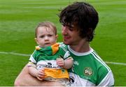 1 August 2021; Offaly captain Ben Conneely with his daughter Liadán, 8 months, on the pitch after his side's victory in the Christy Ring Cup Final match between Derry and Offaly at Croke Park in Dublin. Photo by Piaras Ó Mídheach/Sportsfile