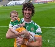 1 August 2021; Offaly captain Ben Conneely with his daughter Liadán, 8 months, on the pitch after his side's victory in the Christy Ring Cup Final match between Derry and Offaly at Croke Park in Dublin. Photo by Piaras Ó Mídheach/Sportsfile