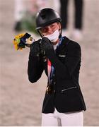 2 August 2021; Julia Krajewski of Germany fixes her mask after receiving her gold medal after winning the eventing jumping individual final at the Equestrian Park during the 2020 Tokyo Summer Olympic Games in Tokyo, Japan. Photo by Brendan Moran/Sportsfile