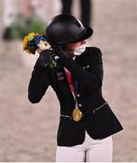 2 August 2021; Julia Krajewski of Germany fixes her mask after receiving her gold medal after winning the eventing jumping individual final at the Equestrian Park during the 2020 Tokyo Summer Olympic Games in Tokyo, Japan. Photo by Brendan Moran/Sportsfile