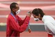 2 August 2021; Joint gold medalists Mutaz Essa Barshim of Qatar, left, presents Gianmarco Tamberi of Italy with his gold medal during the Men's High Jump Victory Ceremony at the Olympic Stadium on day ten of the 2020 Tokyo Summer Olympic Games in Tokyo, Japan. Photo by Ramsey Cardy/Sportsfile