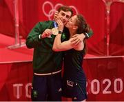 3 August 2021; Michaela Walsh of Ireland kisses her brother Aidan Walsh of Ireland, wearing a cast, with his bronze medal that he won in the men's welterweight division at the Kokugikan Arena during the 2020 Tokyo Summer Olympic Games in Tokyo, Japan. Photo by Brendan Moran/Sportsfile