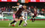 3 August 2021; Andy Lyons of Bohemians in action against Shinji Kagawa of PAOK during the UEFA Europa Conference League third qualifying round first leg match between Bohemians and PAOK at Aviva Stadium in Dublin. Photo by Ben McShane/Sportsfile