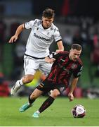 3 August 2021; Liam Burt of Bohemians in action against Thomas Murg of PAOK during the UEFA Europa Conference League third qualifying round first leg match between Bohemians and PAOK at Aviva Stadium in Dublin. Photo by Ben McShane/Sportsfile