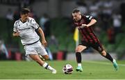 3 August 2021; Liam Burt of Bohemians in action against Thomas Murg of PAOK during the UEFA Europa Conference League third qualifying round first leg match between Bohemians and PAOK at Aviva Stadium in Dublin. Photo by Ben McShane/Sportsfile
