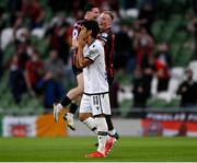 3 August 2021; Shinji Kagawa of PAOK reacts as Ali Coote of Bohemians celebrates after scoring his side's second goal during the UEFA Europa Conference League third qualifying round first leg match between Bohemians and PAOK at Aviva Stadium in Dublin. Photo by Harry Murphy/Sportsfile