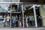 5 August 2021; People watch the race from inside a nearby building during the men's 20 kilometre walk final at Sapporo Odori Park on day 13 during the 2020 Tokyo Summer Olympic Games in Sapporo, Japan. Photo by Ramsey Cardy/Sportsfile