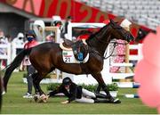 6 August 2021; Leda Guimaraes of Brazil falls from Caleansiena YH during the women's riding show jumping at Tokyo Stadium on day 14 during the 2020 Tokyo Summer Olympic Games in Tokyo, Japan. Photo by Stephen McCarthy/Sportsfile