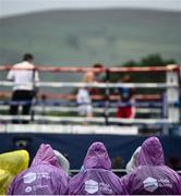 6 August 2021; Spectators wearing ponchos look on at Falls Park in Belfast. Photo by David Fitzgerald/Sportsfile