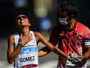 7 August 2021; Cristina Marcela Gomez of Argentina, is escorted by medical officer Paolo Emilio Adami, after finishing in 61st place in the women's marathon at Sapporo Odori Park on day 15 during the 2020 Tokyo Summer Olympic Games in Sapporo, Japan. Photo by Ramsey Cardy/Sportsfile