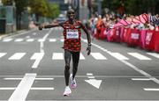 8 August 2021; Eliud Kipchoge of Kenya celebrates as he crosses the finish line to win the men's marathon at Sapporo Odori Park on day 16 during the 2020 Tokyo Summer Olympic Games in Sapporo, Japan. Photo by Ramsey Cardy/Sportsfile