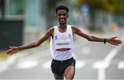 8 August 2021; Tachlowini Gabriyesos of Refugee Olympic Team celebrates crossing the finish line during the men's marathon at Sapporo Odori Park on day 16 during the 2020 Tokyo Summer Olympic Games in Sapporo, Japan. Photo by Ramsey Cardy/Sportsfile