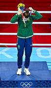 8 August 2021; Kellie Harrington of Ireland puts on her her gold medal during the medal ceremony after defeating Beatriz Ferreira of Brazil in their women's lightweight final bout with at the Kokugikan Arena during the 2020 Tokyo Summer Olympic Games in Tokyo, Japan. Photo by Brendan Moran/Sportsfile