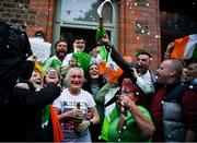 8 August 2021; Champagne flows as Kellie Harrington's mother Yvonne is congratulated outside her Portland Row home, after watching Kellie's Tokyo 2020 Olympics lightweight final bout against Beatriz Ferreira of Brazil. Photo by Ray McManus/Sportsfile