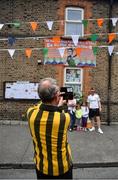8 August 2021; Kilkenny supporter Michael Gannon, from Kilkenny city, takes a picture outside Olympic champion Kellie Harrington's house ahead of the GAA Hurling All-Ireland Senior Championship semi-final match between Kilkenny and Cork at Croke Park in Dublin. Photo by Daire Brennan/Sportsfile