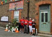 8 August 2021; Cork supporters, from left, Brian Downey, Peter Downey, Geraldine Downey, and Ryan Downey, from Inniscarra, Co Cork, outside Olympic champion Kellie Harrington's house ahead of the GAA Hurling All-Ireland Senior Championship semi-final match between Kilkenny and Cork at Croke Park in Dublin. Photo by Daire Brennan/Sportsfile