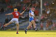 9 August 2021; Peter Cummins of Waterford scores a point under pressure from Cillian Tobin of Cork during the Electric Ireland Munster Minor Hurling Championship Final match between Cork and Waterford at Semple Stadium in Thurles, Tipperary. Photo by Piaras Ó Mídheach/Sportsfile