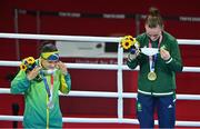 8 August 2021; Silver medallist Beatriz Ferreira of Brazil, left, and gold medallist Kellie Harrington of Ireland put on their facemasks after receiving their medals during the victory ceremony after their women's lightweight final bout at the Kokugikan Arena during the 2020 Tokyo Summer Olympic Games in Tokyo, Japan. Photo by Brendan Moran/Sportsfile