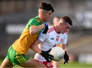 13 August 2021; Paddy McCann of Tyrone in action against Conor Reid of Donegal during the Electric Ireland Ulster GAA Football Minor Championship Final match between Donegal and Tyrone at Brewster Park in Enniskillen, Fermanagh. Photo by Ben McShane/Sportsfile