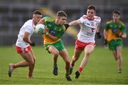 13 August 2021; Kevin McCormack of Donegal evades the tackle of Ronan Cassidy of Tyrone during the Electric Ireland Ulster GAA Football Minor Championship Final match between Donegal and Tyrone at Brewster Park in Enniskillen, Fermanagh. Photo by Ben McShane/Sportsfile