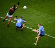 14 August 2021; Paddy Small, 10, kicks a point as Dublin team-mate Ciarán Kilkenny ducks out of the way and Diarmuid O'Connor of Mayo attempts to block during the GAA Football All-Ireland Senior Championship semi-final match between Dublin and Mayo at Croke Park in Dublin. Photo by Stephen McCarthy/Sportsfile