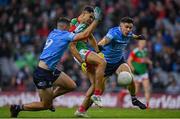 14 August 2021; Tommy Conroy of Mayo kicks a point under pressure from David Byrne, right, and Brian Howard of Dublin during the GAA Football All-Ireland Senior Championship semi-final match between Dublin and Mayo at Croke Park in Dublin. Photo by Seb Daly/Sportsfile