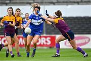 15 August 2021; Eva Galvin of Laois shoots to score her side's first goal, under pressure from Róisín Murphy of Wexford, during the TG4 All-Ireland Intermediate Ladies Football Championship Semi-Final match between Laois and Wexford at UPMC Nowlan Park in Kilkenny. Photo by Piaras Ó Mídheach/Sportsfile
