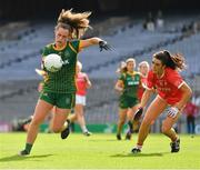 15 August 2021; Emma Duggan of Meath, under pressure from Erika O'Shea of Cork, prepares to kick what proved to be the winning point during the TG4 All-Ireland Senior Ladies Football Championship Semi-Final match between Cork and Meath at Croke Park in Dublin. Photo by Ray McManus/Sportsfile