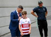 22 August 2021; Former Cork goalkeeper Anthony Nash signs the shirt of Cathal Meade, aged 10, from Mitchelstown, before the GAA Hurling All-Ireland Senior Championship Final match between Cork and Limerick in Croke Park, Dublin. Photo by Ramsey Cardy/Sportsfile