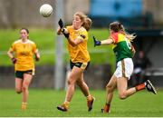 22 August 2021; Cathy Carey of Antrim hand-passes despite the attention of Ellen Atkinson of Carlow during the TG4 All-Ireland Ladies Football Junior Championship Semi-Final match between Antrim and Carlow at Lannleire GFC in Dunleer, Louth. Photo by Ben McShane/Sportsfile