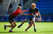 25 August 2021; Ethan Fennell of Metropolitan is tackled by Jude Woods, right, and Paddy Kelly of North-East during the Shane Horgan Cup Round 2 match between Metro and North East at Energia Park in Dublin.  Photo by Eóin Noonan/Sportsfile