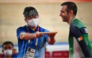 26 August 2021; A steward holds up a phone on a tray as Ronan Grimes of Ireland is interviewed after competing in the Men's C4-5 1000 metre time trial at the Izu Velodrome on day two during the Tokyo 2020 Paralympic Games in Tokyo, Japan. Photo by David Fitzgerald/Sportsfile