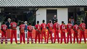 27 August 2021; Zimbabwe players during their national anthem before match one of the Dafanews T20 series between Ireland and Zimbabwe at Clontarf Cricket Club in Dublin. Photo by Seb Daly/Sportsfile