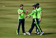27 August 2021; Andrew Balbirnie of Ireland, right, is congratulated by team-mate Barry McCarthy, left, after running-out Zimbabwe's Ryan Burl during match one of the Dafanews T20 series between Ireland and Zimbabwe at Clontarf Cricket Club in Dublin. Photo by Seb Daly/Sportsfile