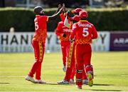 27 August 2021; Luke Jongwe of Zimbabwe celebrates with team-mates after taking the wicket of Ireland's Paul Stirling during match one of the Dafanews T20 series between Ireland and Zimbabwe at Clontarf Cricket Club in Dublin. Photo by Seb Daly/Sportsfile
