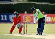 27 August 2021; Kevin O’Brien of Ireland plays a shot, watched by Zimbabwe wicketkeeper Regis Chakabva, during match one of the Dafanews T20 series between Ireland and Zimbabwe at Clontarf Cricket Club in Dublin. Photo by Seb Daly/Sportsfile
