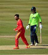 27 August 2021; Ryan Burl of Zimbabwe celebrates taking the wicket of Ireland's Kevin O’Brien during match one of the Dafanews T20 series between Ireland and Zimbabwe at Clontarf Cricket Club in Dublin. Photo by Seb Daly/Sportsfile