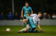 28 August 2021; Eoin O'Neill of Maynooth Town is tackled by Lee Devitt of Cobh Ramblers during the extra.ie FAI Cup Second Round match between Maynooth University Town and Cobh Ramblers at John Hyland Park in Baldonnell, Dublin. Photo by Eóin Noonan/Sportsfile
