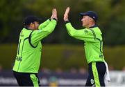 29 August 2021; Harry Tector of Ireland, right, is congratulated by team-mate Paul Stirling after running-out Zimbabwe's Tadiwanashe Marumani during match two of the Dafanews T20 series between Ireland and Zimbabwe at Clontarf Cricket Club in Dublin. Photo by Seb Daly/Sportsfile