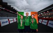 31 August 2021; Katie-George Dunlevy, left, and Eve McCrystal of Ireland with head coach Neill Delahaye, celebrate with the Irish tri-colour after winning gold in the Women's B Time Trial at the Fuji International Speedway on day seven during the Tokyo 2020 Paralympic Games in Shizuoka, Japan. Photo by David Fitzgerald/Sportsfile