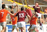 20 July 2013; Danny Cummins, Galway, punches the ball into the Armagh net despite the tackles of Brendan Donaghy and Paul McKeown, Armagh. GAA Football All-Ireland Senior Championship, Round 3, Galway v Armagh, Pearse Stadium, Salthill, Galway. Picture credit: Ray Ryan / SPORTSFILE