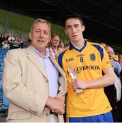21 July 2013; Cathal Compton, Roscommon,  is presented with the Electric Ireland Man of the Match award by  Kevin Molloy, CRM, Electric Ireland. Connacht GAA Football Minor Championship Final, Roscommon v Mayo, Elverys MacHale Park, Castlebar, Co. Mayo Picture credit: Ray McManus / SPORTSFILE