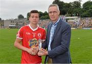21 July 2013; Tyrone's Connor McKenna, who was presented with the Electric Ireland Man of the Match award by Frank O'Brien, Customer Relationships Manager, Electric Ireland. Electric Ireland Ulster GAA Football Minor Championship Final, Monaghan v Tyrone, St Tiernach's Park, Clones, Co. Monaghan. Picture credit: Brian Lawless / SPORTSFILE