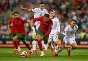 1 September 2021; Cristiano Ronaldo of Portugal in action against Josh Cullen, left, and Jeff Hendrick of Republic of Ireland during the FIFA World Cup 2022 qualifying group A match between Portugal and Republic of Ireland at Estádio Algarve in Faro, Portugal. Photo by Seb Daly/Sportsfile