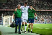 1 September 2021; Dara O'Shea of Republic of Ireland is assisted from the pitch by Republic of Ireland team doctor Alan Byrne, left, and chartered physiotherapist Kevin Mulholland after picking up an injury during the FIFA World Cup 2022 qualifying group A match between Portugal and Republic of Ireland at Estádio Algarve in Faro, Portugal. Photo by Stephen McCarthy/Sportsfile