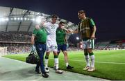 1 September 2021; Dara O'Shea of Republic of Ireland is greeted by James Collins, right, as he is assisted from the pitch by Republic of Ireland team doctor Alan Byrne, left, and chartered physiotherapist Kevin Mulholland after picking up an injury during the FIFA World Cup 2022 qualifying group A match between Portugal and Republic of Ireland at Estádio Algarve in Faro, Portugal. Photo by Stephen McCarthy/Sportsfile