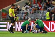 1 September 2021; Aaron Connolly of Republic of Ireland is treated for an injury by Republic of Ireland team doctor Alan Byrne, left, and chartered physiotherapist Kevin Mulholland during the FIFA World Cup 2022 qualifying group A match between Portugal and Republic of Ireland at Estádio Algarve in Faro, Portugal. Photo by Stephen McCarthy/Sportsfile