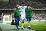 1 September 2021; Dara O'Shea of Republic of Ireland leaves the pitch after picking up an injury assisted by Republic of Ireland team doctor Alan Byrne, left, and Republic of Ireland chartered physiotherapist Kevin Mulholland during the FIFA World Cup 2022 qualifying group A match between Portugal and Republic of Ireland at Estádio Algarve in Faro, Portugal. Photo by Stephen McCarthy/Sportsfile