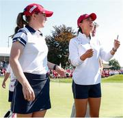 5 September 2021; Danielle Kang and Austin Ernst of Team USA react to winning their match on the 18th green during the morning foursomes on day two of the Solheim Cup at the Inverness Club in Toledo, Ohio, USA. Photo by Brian Spurlock/Sportsfile